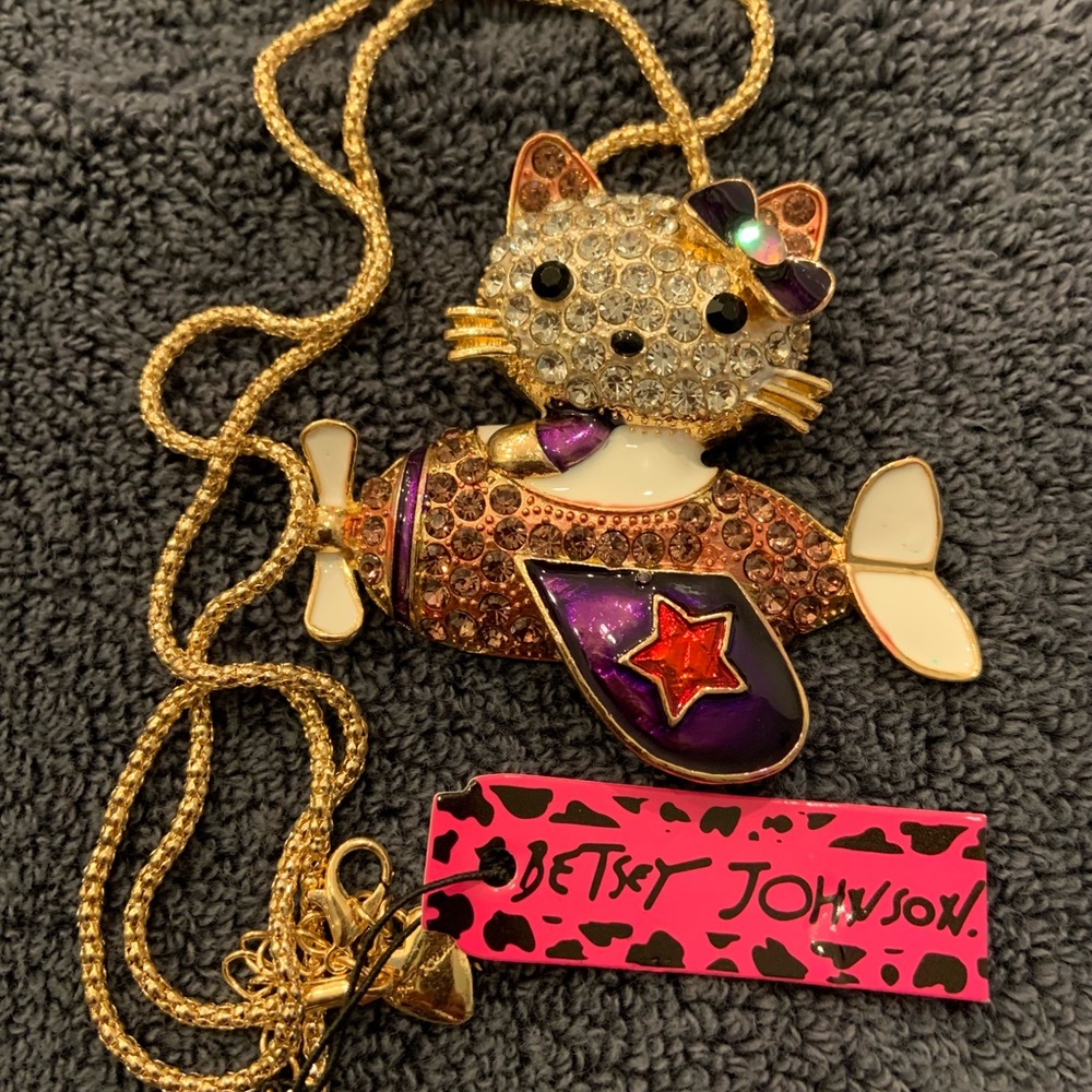1/2 off sale!  Hello Kitty in a mauve necklace airplane, crystal colored wings.